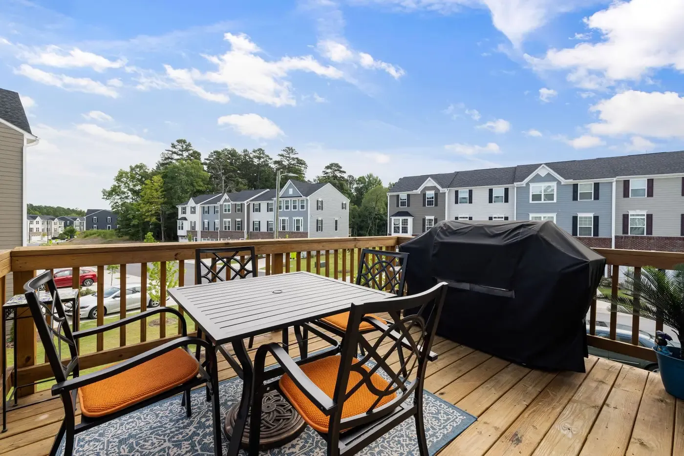 Finished backyard deck with railings overlooking a lawn