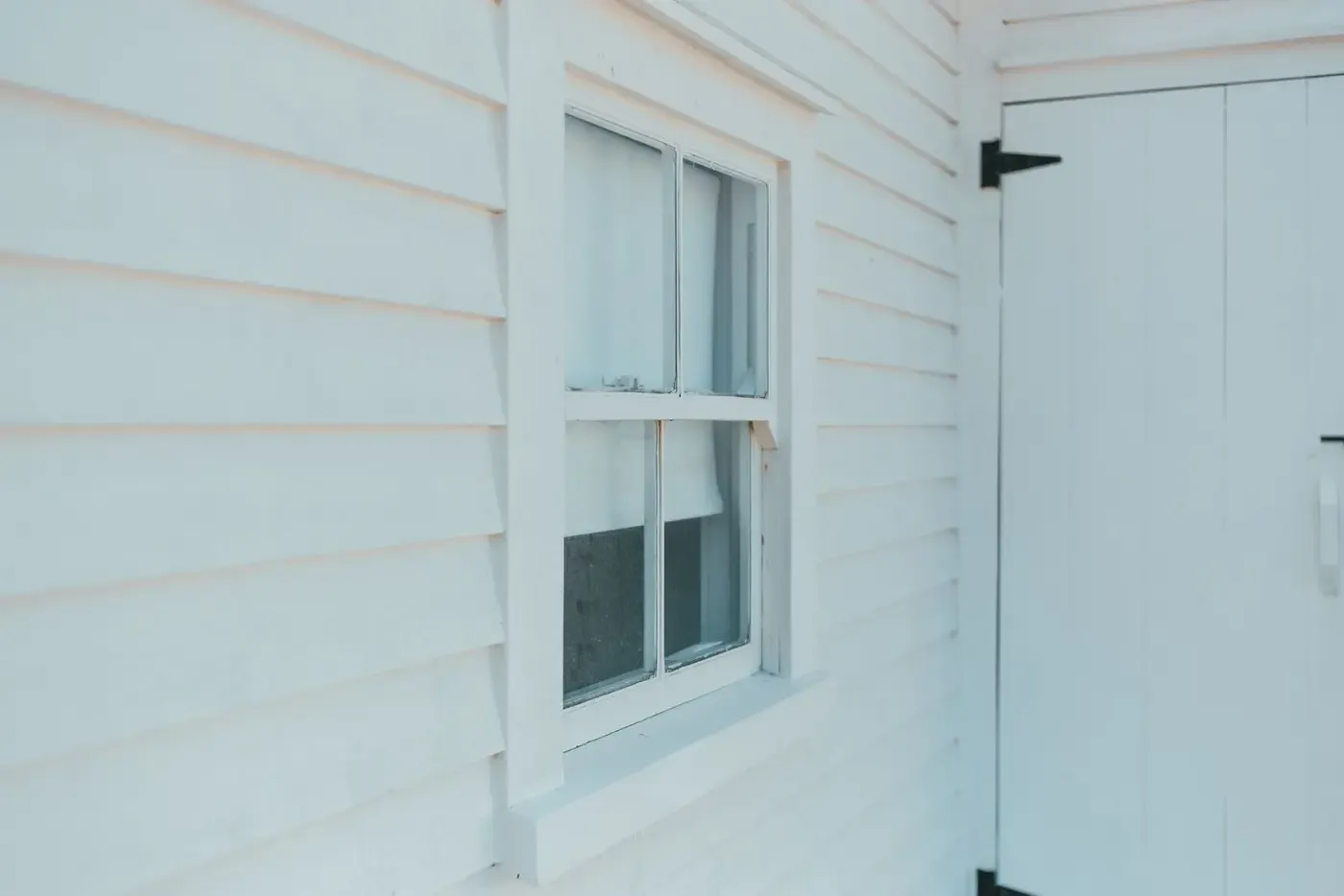 Lap siding and trim detail on a white house exterior