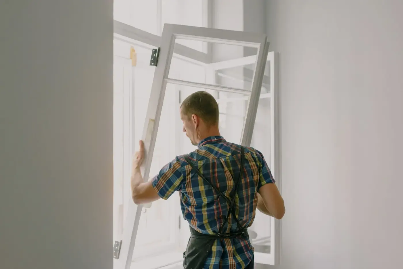 Installer setting a replacement window into a prepared opening